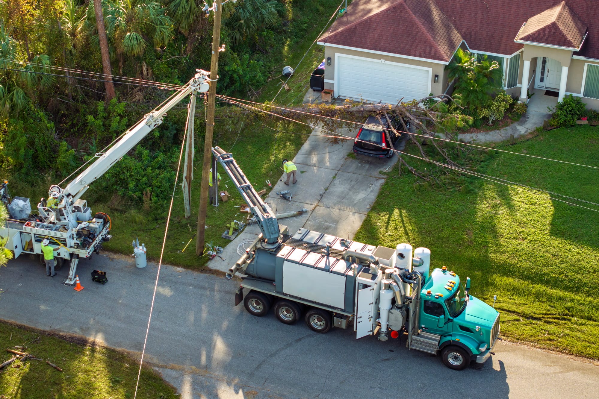 Utility services fixing damaged power lines after hurricane