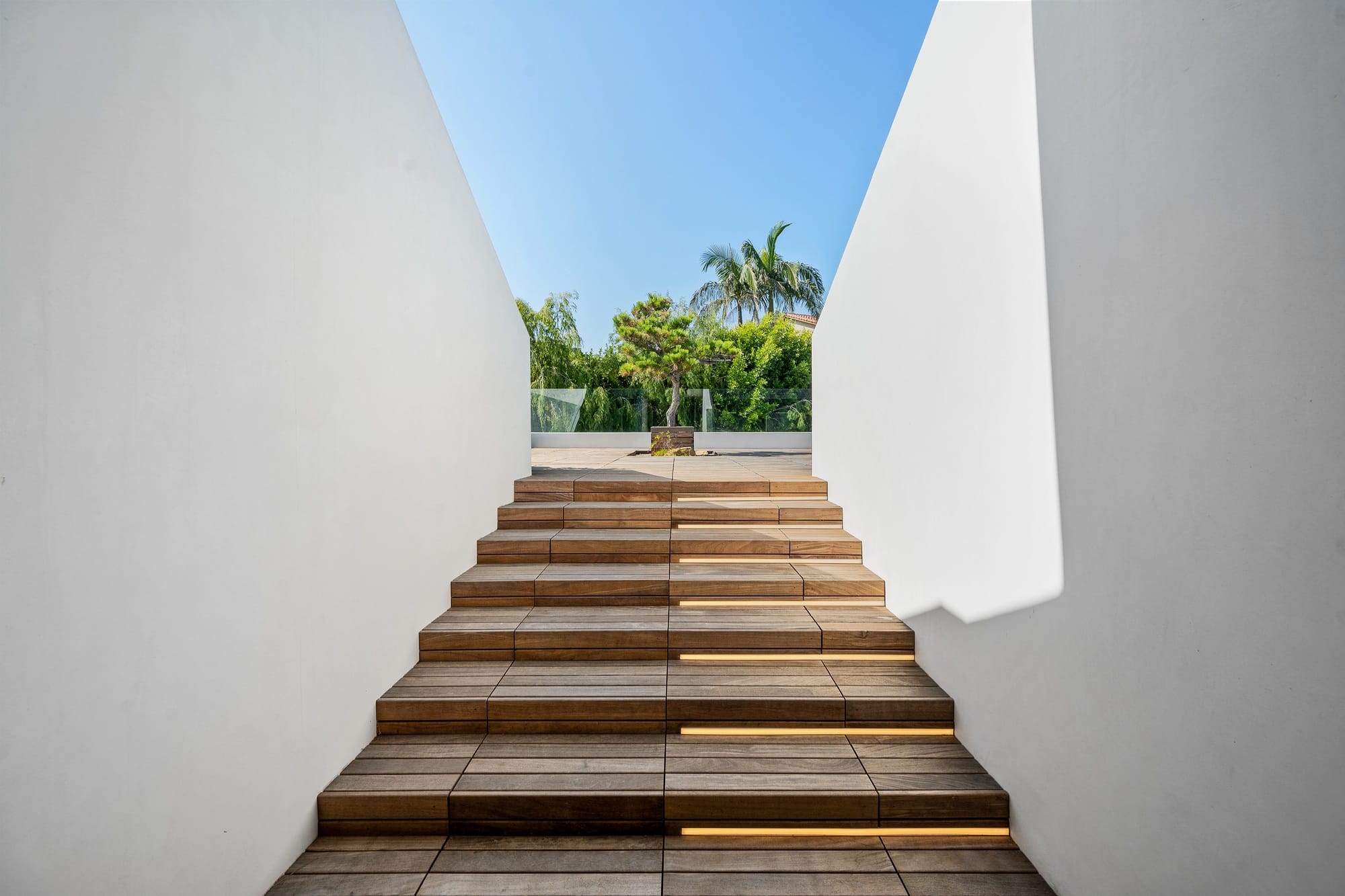 an architectural structure made from wood and concrete, has stairs made out of wood and