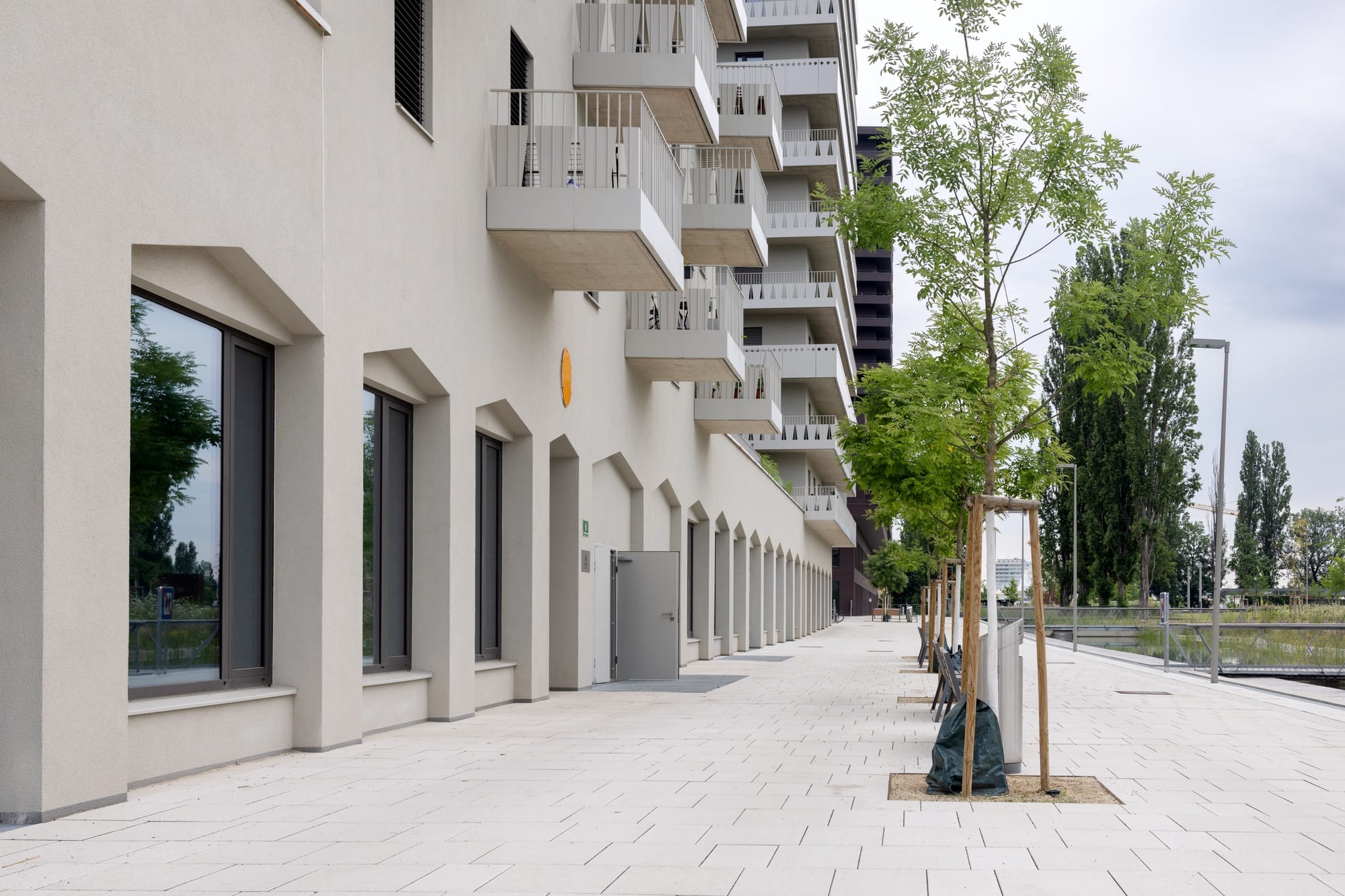 Commercial ground floor of building and pedestrian area, residential buildings, modern architecture