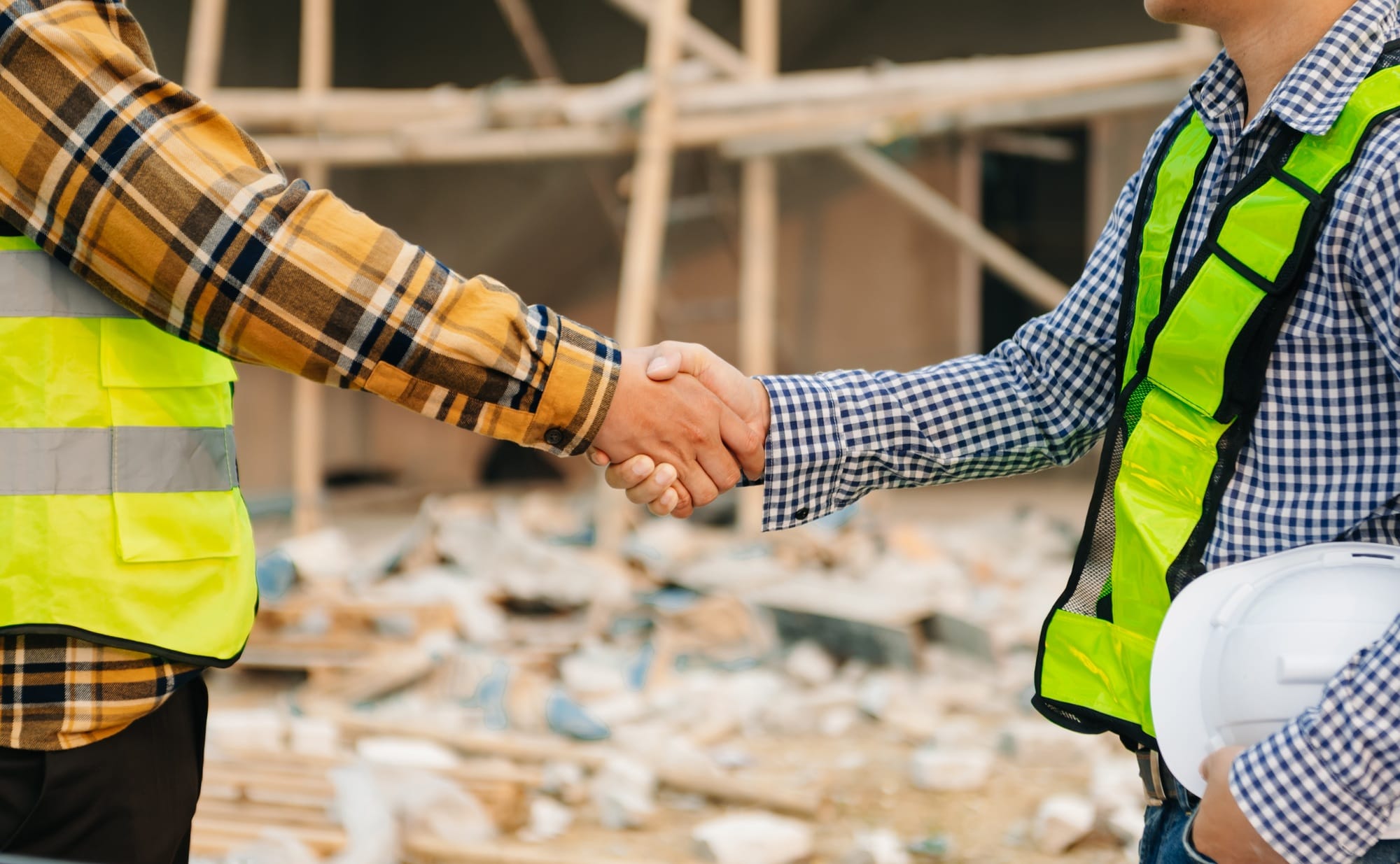 Engineer and contractor join hands after signing contract,They are having a modern building project